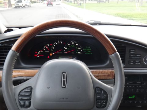 2000 Lincoln Continental - Interior view of a 2000 Lincoln Continental, displaying the steering wheel and dashboard.