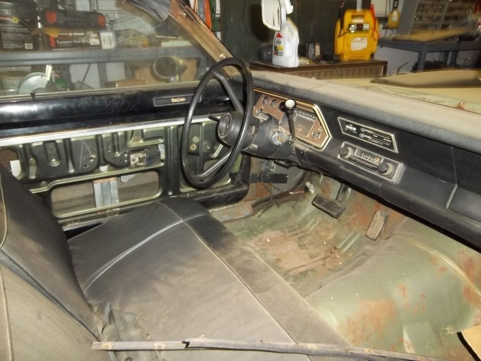 Interior of a 1971 Dodge Dart showing the dashboard, steering wheel, and seats