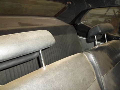1971 Dodge Dart - Interior view of a car, showing the seats and headrests covered in dust.