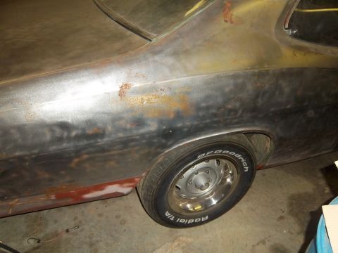 1971 Dodge Dart - The rear side of a 1971 Dodge Dart shows significant rust and primer patches, with a steel wheel and BFGoodrich tire visible.