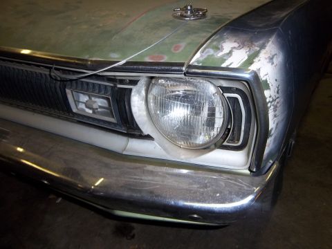 1971 Dodge Dart - Close-up of the front corner of a 1971 Dodge Dart, highlighting the headlight and grille area.