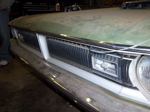 1971 Dodge Dart - Close-up of a car's front end, showing the grille and headlight assembly.