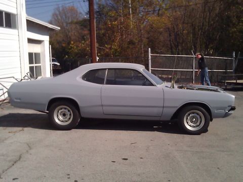 1971 Dodge Dart - A gray 1971 Dodge Dart coupe is parked outside with its hood open, showing the engine bay.