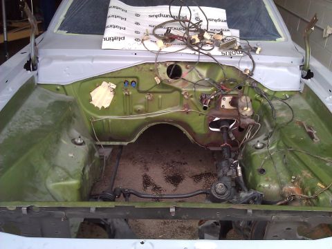 1971 Dodge Dart - The engine bay of a 1971 Dodge Dart is shown during a restoration project, with the wiring harness and brake system components exposed.