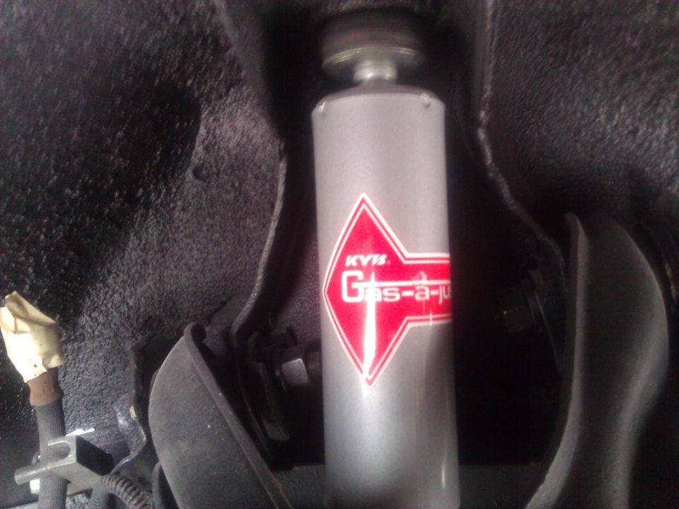 KYB Gas-a-just shock absorber with red and white logo