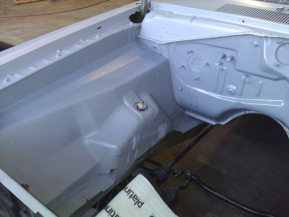 1971 Dodge Dart engine bay, painted gray, with shock tower and inner fender visible