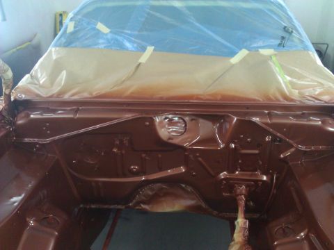 1971 Dodge Dart - The engine bay of a car is being prepped and painted, with the windshield covered for protection.