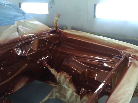 1971 Dodge Dart - The engine bay of a vehicle is being painted brown and is covered in protective masking tape.