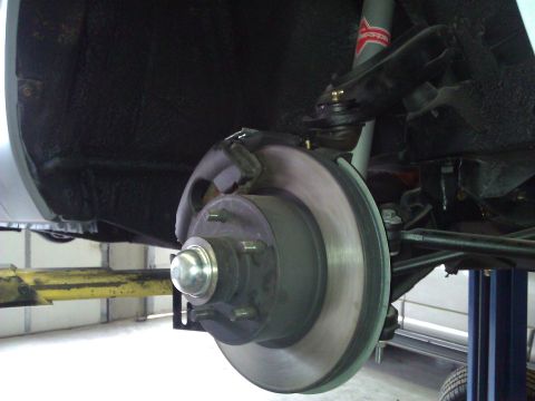 1971 Dodge Dart - A close-up view of a vehicle's brake system and suspension components, likely during maintenance.