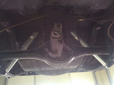 1971 Dodge Dart - Underside view of a vehicle's rear axle, differential, and suspension components.