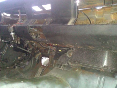 1971 Dodge Dart - View of the exposed dashboard wiring and pedals inside a vehicle.