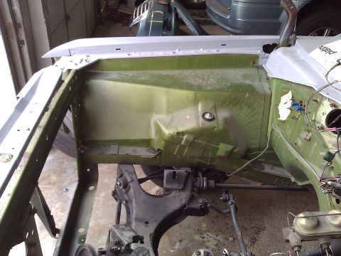 1971 Dodge Dart - Engine bay of a car undergoing restoration, revealing suspension and wiring details.