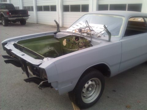 1971 Dodge Dart - A car in primer is parked outside a garage with a truck in the background.
