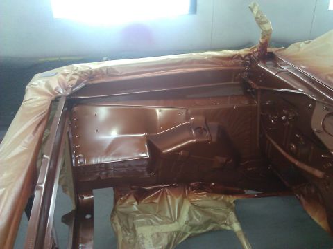 1971 Dodge Dart - The interior of a car is being painted a brown color and is covered with plastic sheeting for protection.