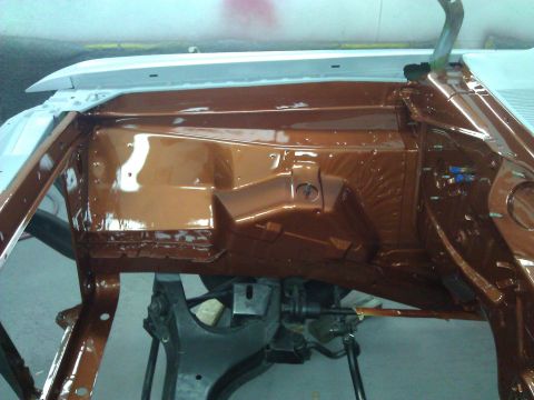 1971 Dodge Dart - The interior of a car chassis, painted in a copper-brown hue, reveals suspension parts and structural elements.