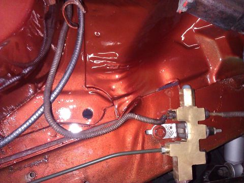 1971 Dodge Dart - Close-up of a brake proportioning valve and associated wiring within an orange-painted engine bay.