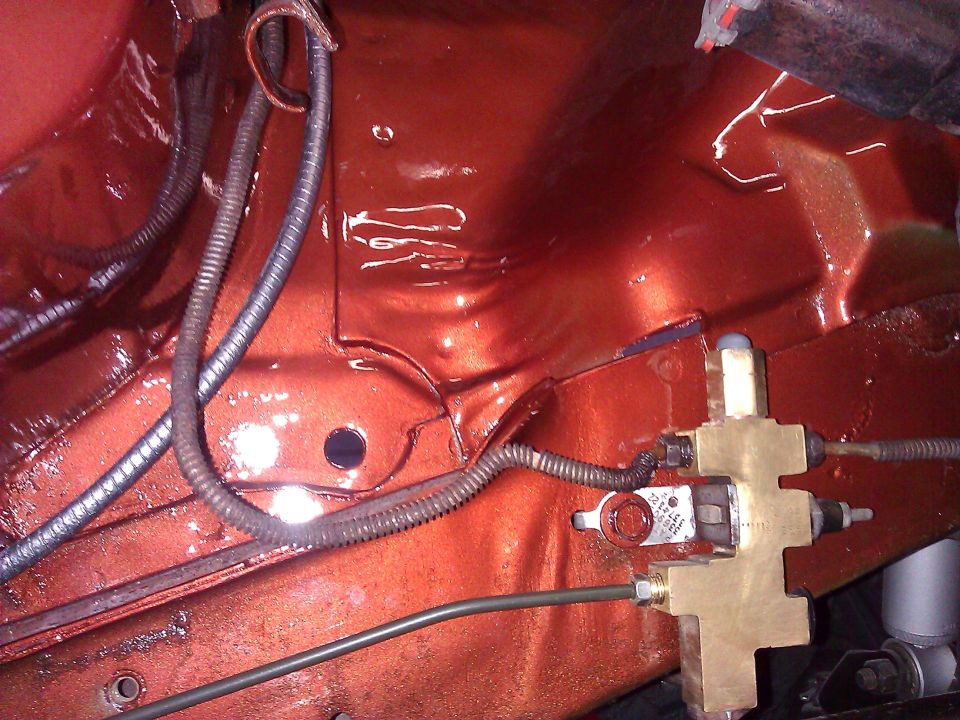 Brake proportioning valve and wiring in orange engine bay
