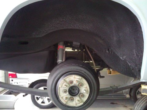 1971 Dodge Dart - Vehicle's rear wheel well and suspension components are visible, with another car in the background.