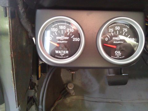 1971 Dodge Dart - Close-up of Auto Meter water temperature and oil pressure gauges installed in a vehicle's interior.