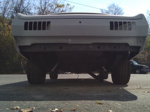 1971 Dodge Dart - The rear of a car, possibly undergoing restoration, is shown with a second vehicle visible in the background.