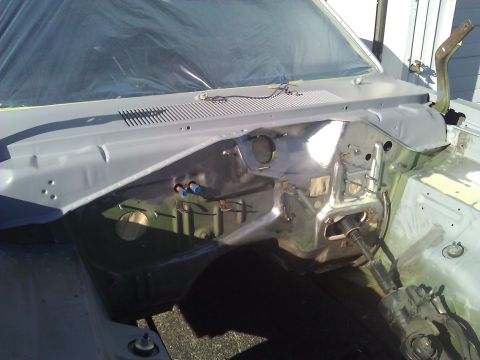 1971 Dodge Dart - The firewall and inner fender area of a car undergoing restoration, with the windshield covered.