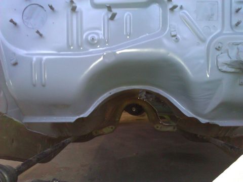 1971 Dodge Dart - The underside of a car chassis is shown, with suspension parts and a wheel well area visible.