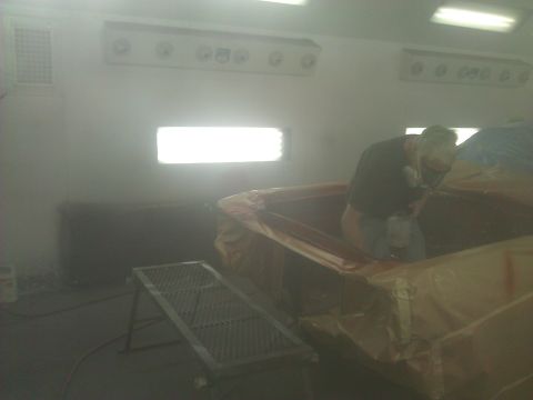 1971 Dodge Dart - Car interior being painted inside a spray booth with bright lights overhead.