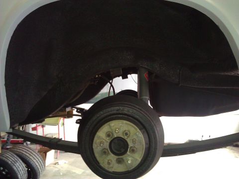 1971 Dodge Dart - Rear suspension and wheel well detail of a vehicle, likely undergoing maintenance.