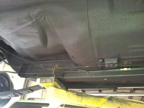 1971 Dodge Dart - The undercarriage of a vehicle is shown, lifted for inspection or repair.