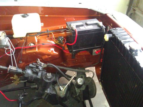 1971 Dodge Dart - Engine bay components including the battery, radiator, and steering assembly are visible in this orange vehicle.