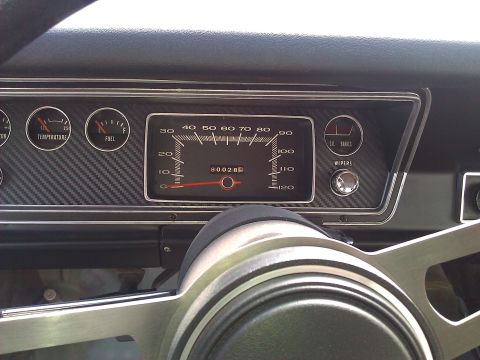 1971 Dodge Dart - Interior view of a 1971 Dodge Dart dashboard, showing various gauges and carbon fiber trim.