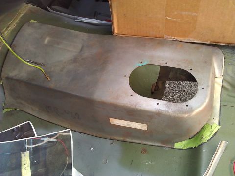 1971 Dodge Dart - A rusty metal car part, possibly a fender or inner panel, with electrical wiring attached and an oval cutout. The part is taped with green…