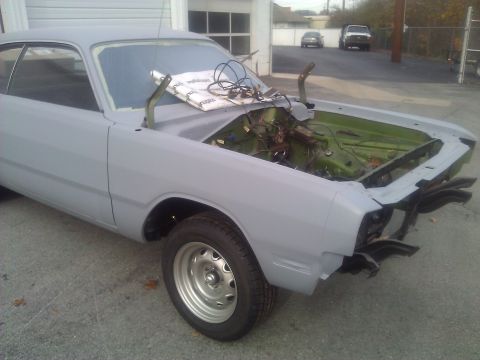 1971 Dodge Dart - This 1971 Dodge Dart is in primer, with its hood open revealing the engine bay and wiring.