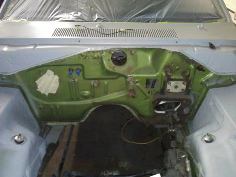 1971 Dodge Dart - Firewall of a 1971 Dodge Dart undergoing restoration, showing the engine bay area with green paint and primer.
