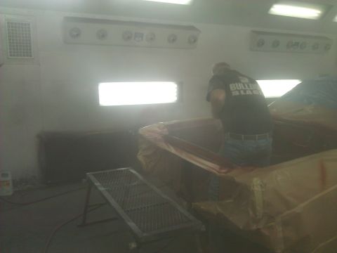 1971 Dodge Dart - A car is being prepped for painting inside a booth, with a worker attending to it.