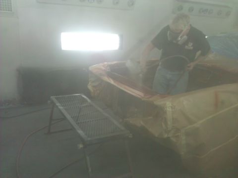 1971 Dodge Dart - Car body undergoing painting inside a spray booth with a worker wearing a respirator.