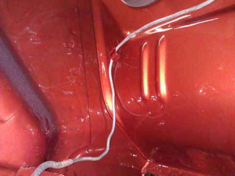 1971 Dodge Dart - Close-up view of the interior of a car trunk, showing orange paint and a wiring harness.