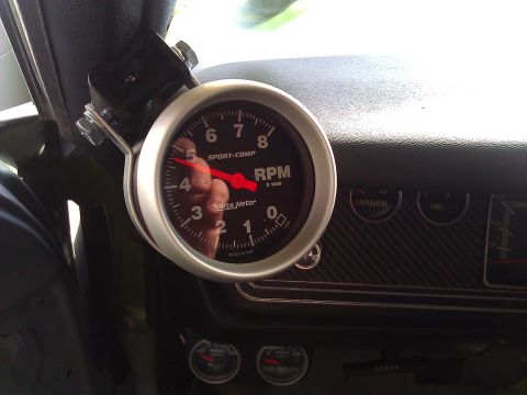 1971 Dodge Dart - Close-up of a car's interior dashboard, showing a tachometer and other gauges.