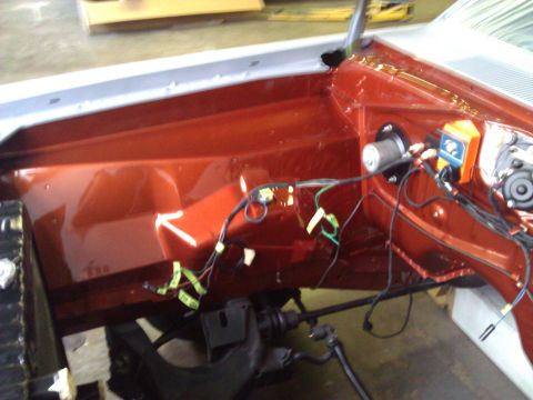 1971 Dodge Dart - The engine bay of a 1971 Dodge Dart shows off its freshly painted orange interior and exposed wiring harness.