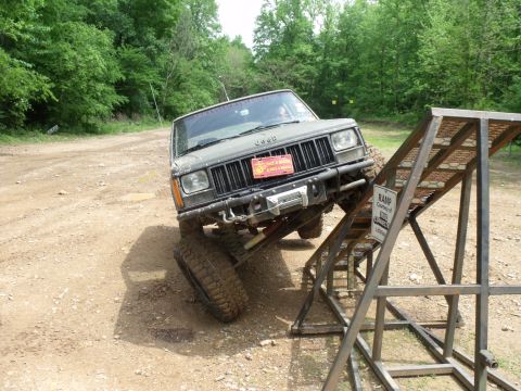1992 Jeep Cherokee - A modified Jeep Cherokee navigates an off-road obstacle course, demonstrating its off-road capabilities.