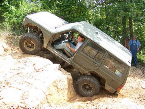 1992 Jeep Cherokee - Driver navigates a steep rock obstacle in a modified Jeep Cherokee.