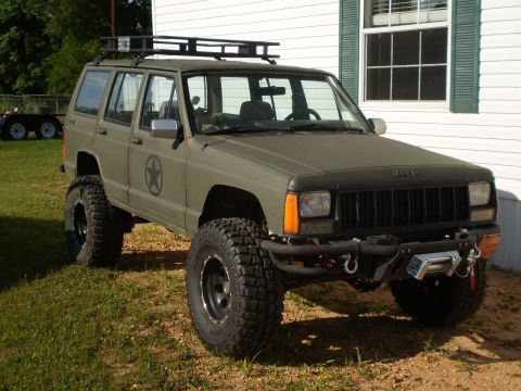 1992 Jeep Cherokee - This modified 1992 Jeep Cherokee features a matte olive drab paint job and off-road tires.