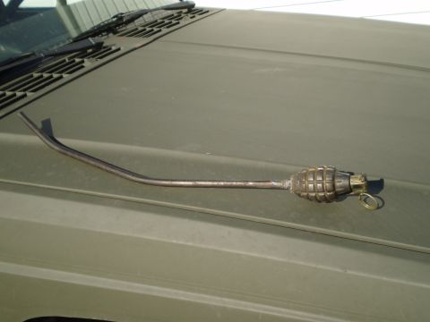 1992 Jeep Cherokee - This 1992 Jeep Cherokee features a unique grenade-shaped antenna topper mounted on its olive drab hood.