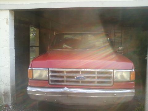 1988 Ford F-150 - Front view of a red 1988 Ford F-150 parked inside a garage.