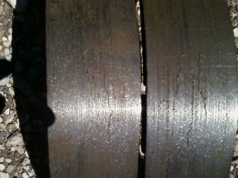 1988 Ford F-150 - Close-up of two severely worn and cracked brake rotors, indicating a need for replacement.
