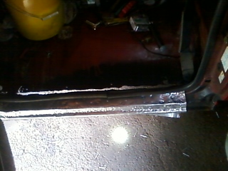 1988 Ford F-150 - The door sill of a vehicle shows significant rust and damage, with the SuperMotors logo visible at the bottom.