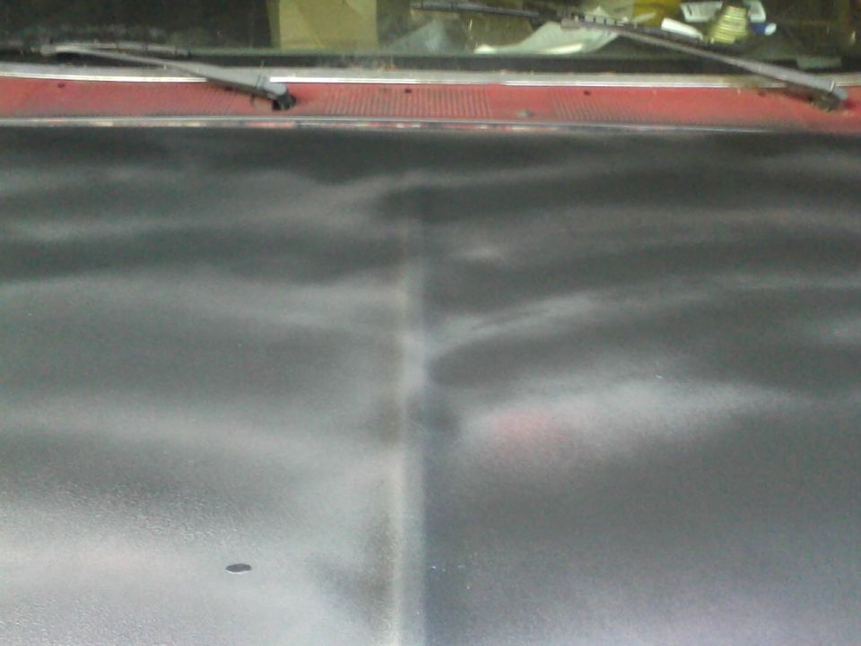Truck hood, red trim, windshield wipers visible. Watermark 'SUPERMOTORS.NET'