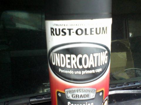 1988 Ford F-150 - A spray can of Rust-Oleum Undercoating is visible in the foreground, obscuring the view of a vehicle's interior.