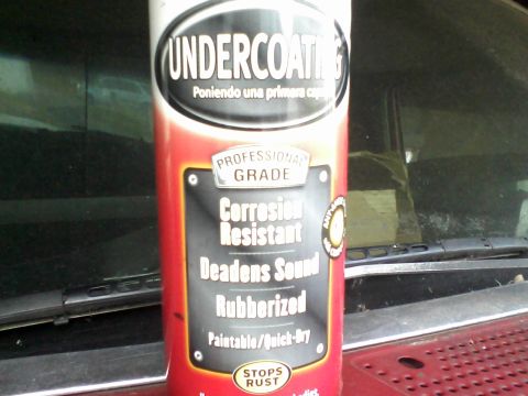 1988 Ford F-150 - A can of undercoating spray is positioned in front of a vehicle's windshield, obscuring most of the view.