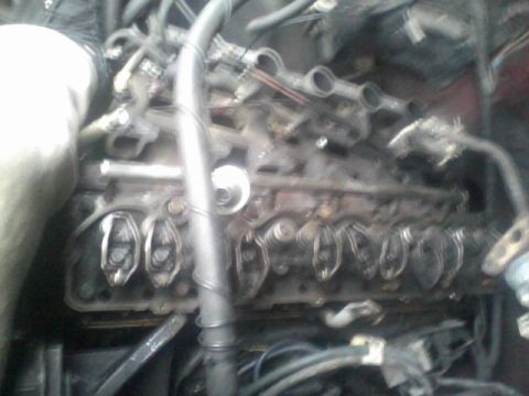 1988 Ford F-150 - Engine bay detail showing the valve train components, including rocker arms and springs, in a vehicle.